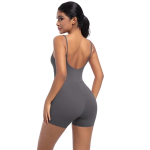 Detail of deep grey backless yoga bodysuit with thin straps and elastic fabric