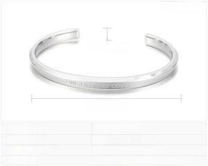 Detail view of 5mm stainless steel cuff bracelet with One Life One Love engraving