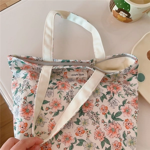 Close-up of floral cotton tote bag with pink flowers and a secure zipper closure
