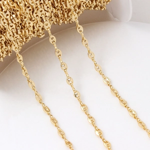Detailed close-up of 18K gold-plated marina chain on a spool for DIY jewelry making