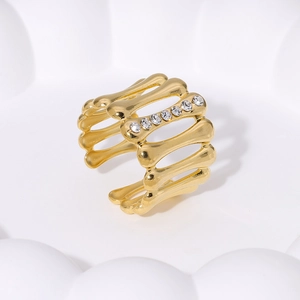 18K gold plated stainless steel geometric bone ring with crystals in a white dish
