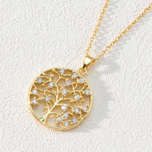 Macro shot of 18K gold plated Tree of Life pendant featuring sparkling zircon crystals