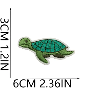 Detailed embroidery texture of green turtle patch with precise size measurements