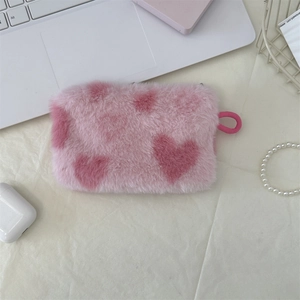 Detail of pink plush heart storage bag with soft texture and vibrant zipper puller