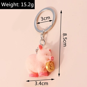 Detailed view of pink pig keychain with gold coin showing weight and size measurements