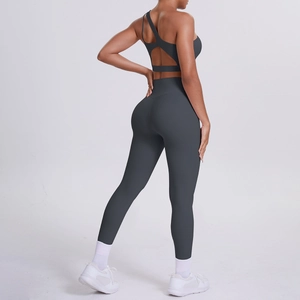 Detail of grey yoga set featuring a back cutout sports bra and high-waisted leggings