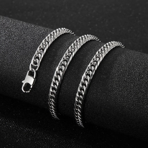 Polished silver stainless steel curb chain with lobster clasp on a display stand