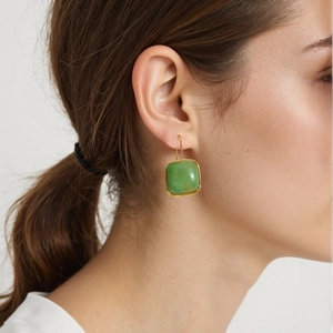 Elegant gold earrings with square green resin charms on a model, minimalist chic style