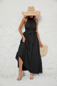 Detail view of black halter maxi dress featuring textured mesh and layered ruffle skirt