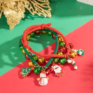 Detail of Christmas braided rope bracelets with Santa Claus and festive metal charms