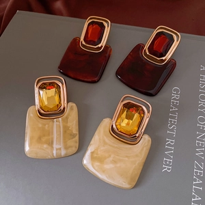 Detail of vintage geometric earrings with tortoiseshell resin and crystal inlay