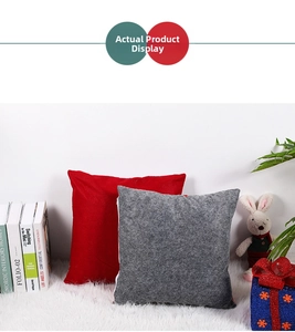 Close-up of red and grey textured Christmas pillow covers on a white plush rug