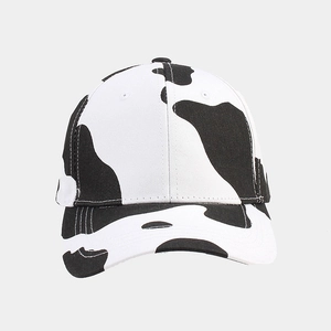 Detail view of the cow print pattern and six-panel structure on a baseball cap
