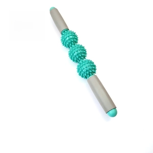 Detailed view of mint green muscle massage roller with triple spiked balls and ergonomic handles