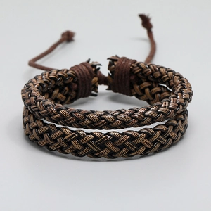 Macro view of woven leather bracelet featuring brown and black braided cord textures
