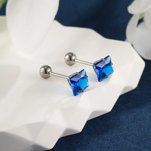 Detail view of square blue synthetic sapphire stud earrings with screw back fasteners