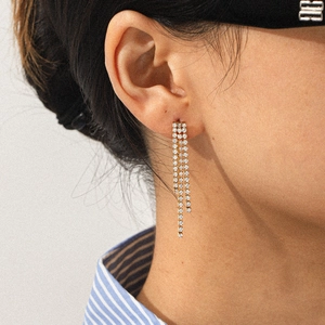 Long gold tassel earrings with stainless steel flowers and hearts featuring white zircon stones