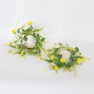 Detailed view of yellow daisy eucalyptus candle rings with white pillar candles