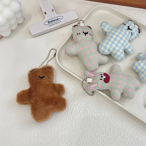 Detailed view of assorted plush bear and rabbit charms with silver beaded chains
