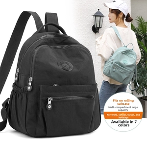 Detail view of water-resistant nylon backpack with luggage strap and multiple compartments