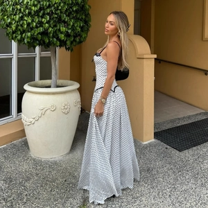 Summer white polka dot halter dress with black lace trim and flowy A-line long skirt