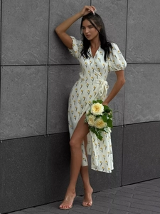 Detail of floral puff sleeve dress featuring a wrap V-neck and yellow tulip print