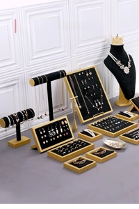 Detailed view of black velvet and gold metal jewelry display stands for store counters