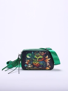 Detail of green crossbody camera bag featuring colorful owl illustration and tassel