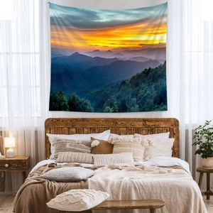 Bohemian wall tapestry featuring a colorful mountain sunset landscape for bedroom decor