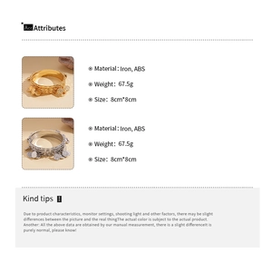 Detail showing iron and ABS coin pendants on a multi-layer gold and silver bangle set