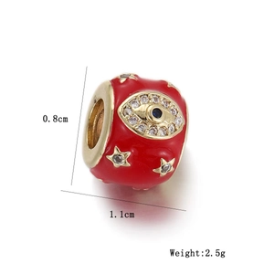 Detail view of red enamel evil eye charm with gold stars and dimensions of 1.1x0.8cm