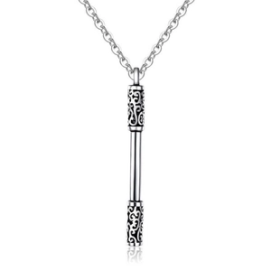 Macro shot of silver Ruyi Jingu Bang pendant with intricate vintage engravings