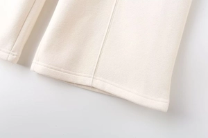 Close-up of cream white flight jacket sleeve with precise double-stitched quilting detail