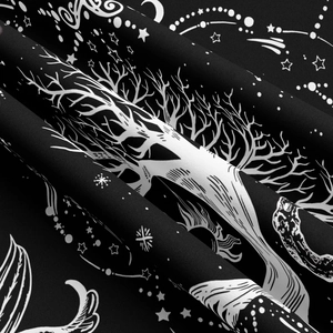 Close-up of black and white Tree of Life tapestry with celestial moon and star patterns