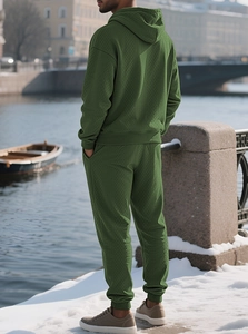 Close-up of dark green waffle knit texture on men's hoodie and jogger sports set