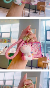 Detail of cute unicorn keychain featuring braided strap and resin charm on metal ring