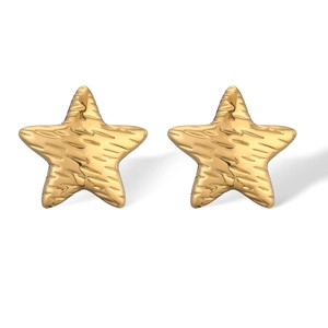 Macro shot of 18K gold plated star earrings with unique textured finish and metal luster