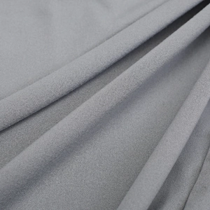 Macro shot of gray newborn swaddle blanket showing soft plain weave fabric texture