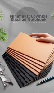 Close-up of minimalist cowhide paper exercise book with visible stitched edge binding