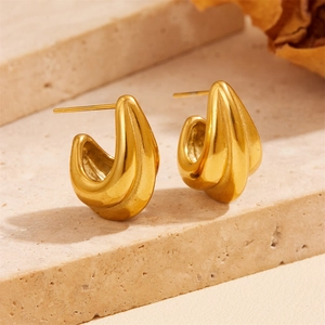 Detailed view of gold plated titanium earrings with a modern fluid geometric shape
