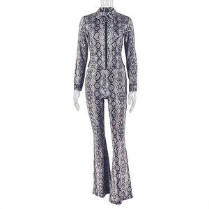 Close-up of snake print jumpsuit featuring front zipper detail and flared leg design
