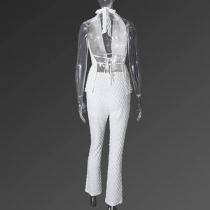 Back view of a white halter neck top and trousers set with textured bubble fabric detail