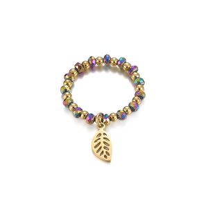 Detail of beaded elastic ring with golden beads, iridescent crystals and leaf charm