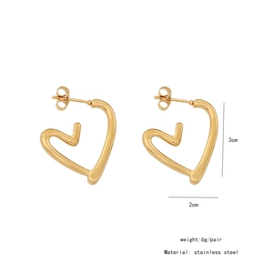 Detail view of heart-shaped gold stainless steel earrings with 3cm by 2cm size specifications
