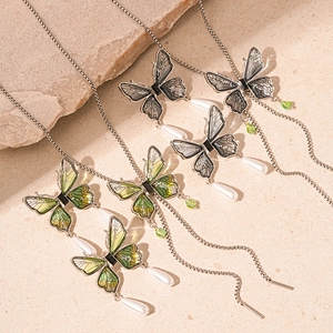 Vintage butterfly pendant necklace with colorful wings and waterdrop pearls on sand stone