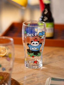 Close-up of a glass cup featuring a colorful cartoon panda and Fancy text design