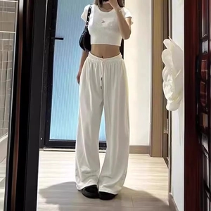 Detail of white high-waisted drawstring wide-leg pants and cropped t-shirt set