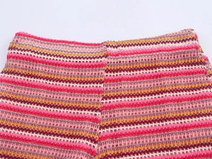 Close-up of colorful striped crochet polo shirt with breathable hollow-out wave texture