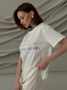 Detail of white cotton T-shirt featuring a pearl necklace print and graphic lettering