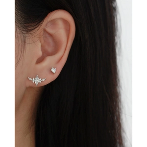 Close-up of s925 silver stud earrings with zircon heart and marquise stones on model's ear